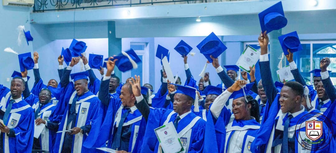 Graduands throwing their caps in celebration